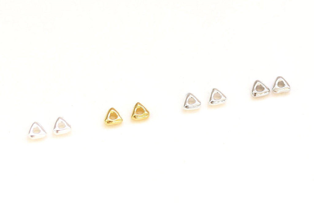 Set of small gold earrings on a white background