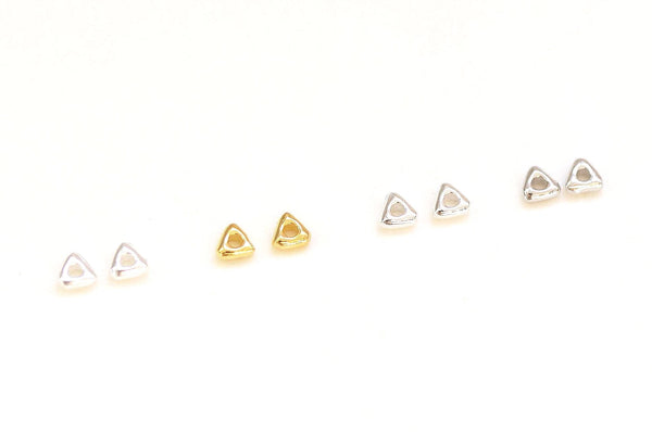 Set of small gold earrings on a white background