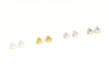 Set of small gold earrings on a white background